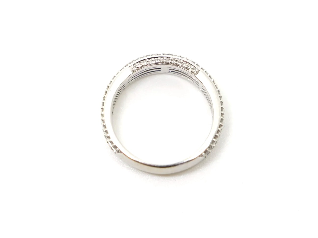 Contemporary 18ct gold triple row diamond three quarter eternity ring, with three rows of diamonds and further diamonds in both top and bottom of setting.