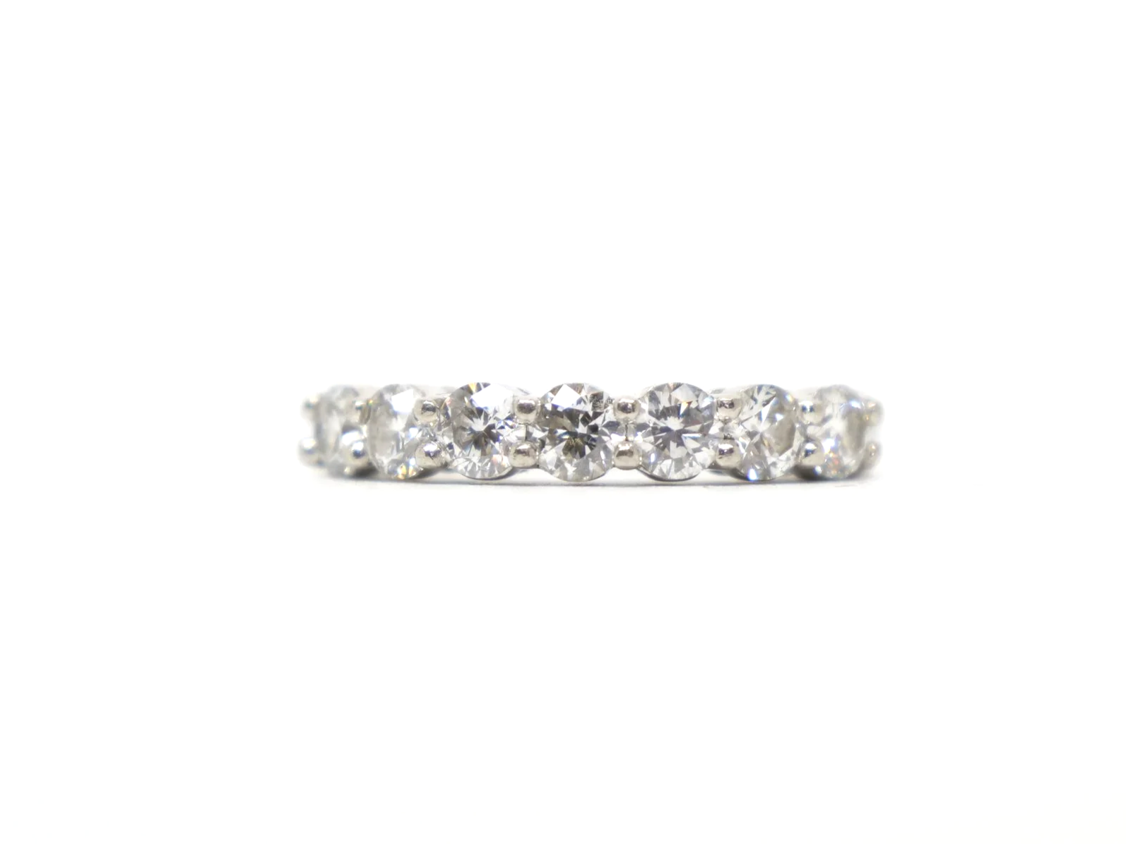 platinum diamond half-eternity ring set with seven round brilliant-cut diamonds