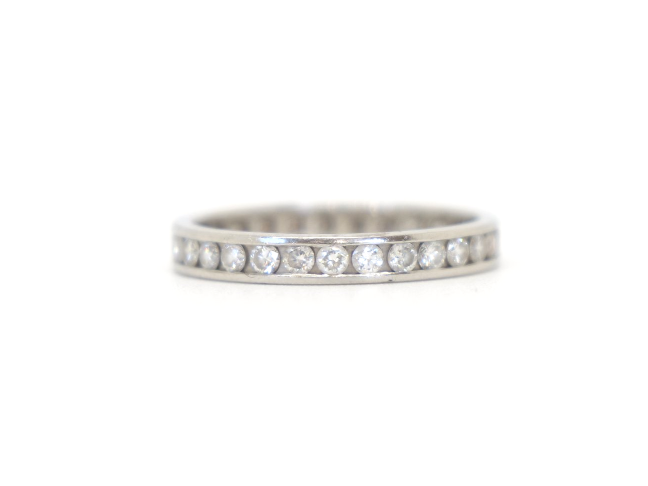 Contemporary platinum diamond full eternity ring, set with approximately 1ct brilliant cut diamonds.