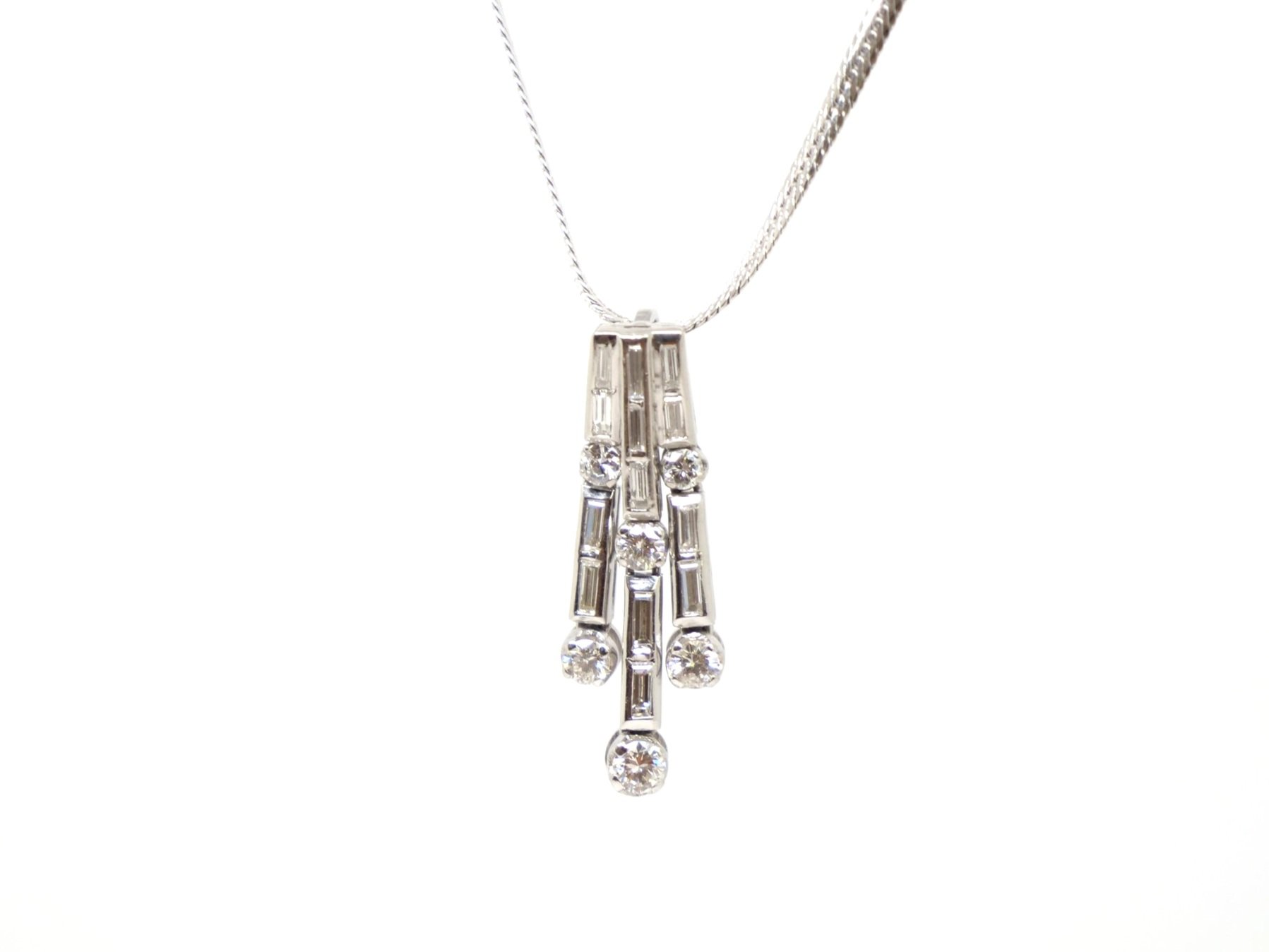 Superb platinum diamond waterfall design pendant, set with a mixture of brilliant and baguette cut diamonds. With platinum chain.