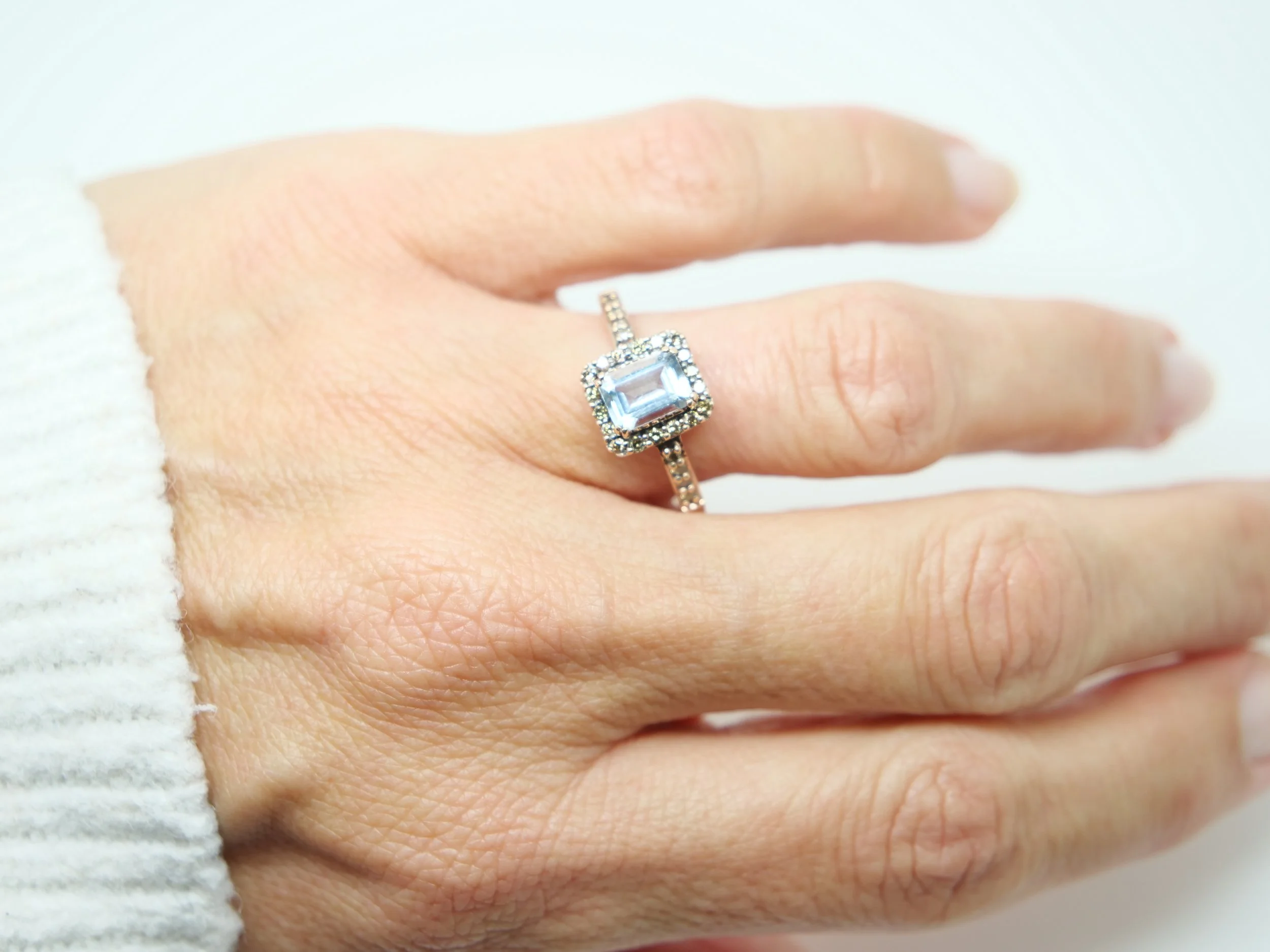 Super 14ct gold aquamarine and diamond cocktail ring, set with an emerald cut aquamarine and surrounded by chocolate diamonds.