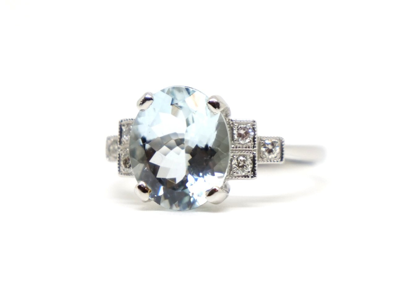 Super platinum Art Deco style aquamarine and diamond ring, set with a central oval cut aquamarine of approximately 3cts, with diamonds set in a step design into each shoulder.