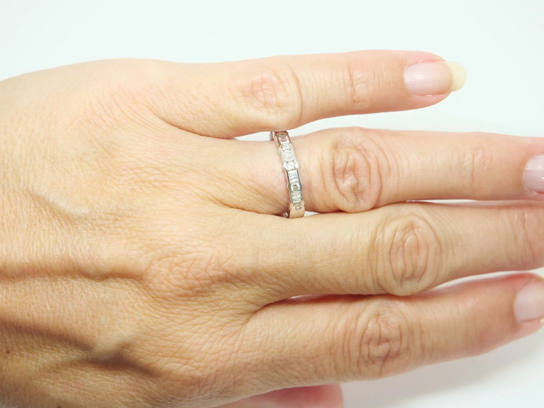 18ct white gold half eternity ring with alternating round and baguette cut diamonds