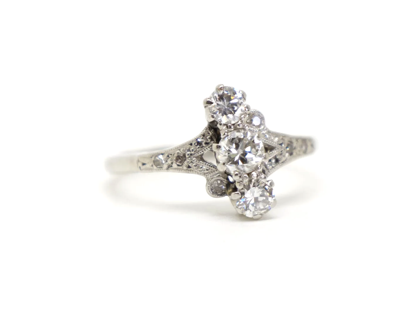 Beautiful platinum Art Deco ring, set with three central diamonds, with further small diamonds set into this unusual design.