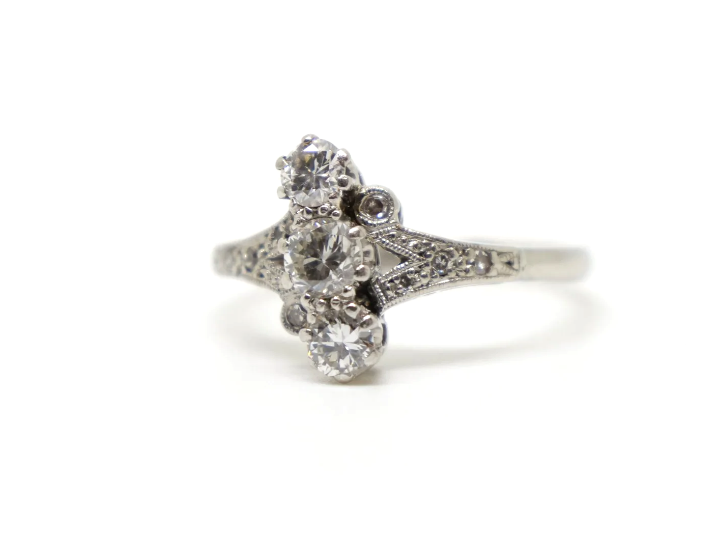 Beautiful platinum Art Deco ring, set with three central diamonds, with further small diamonds set into this unusual design.