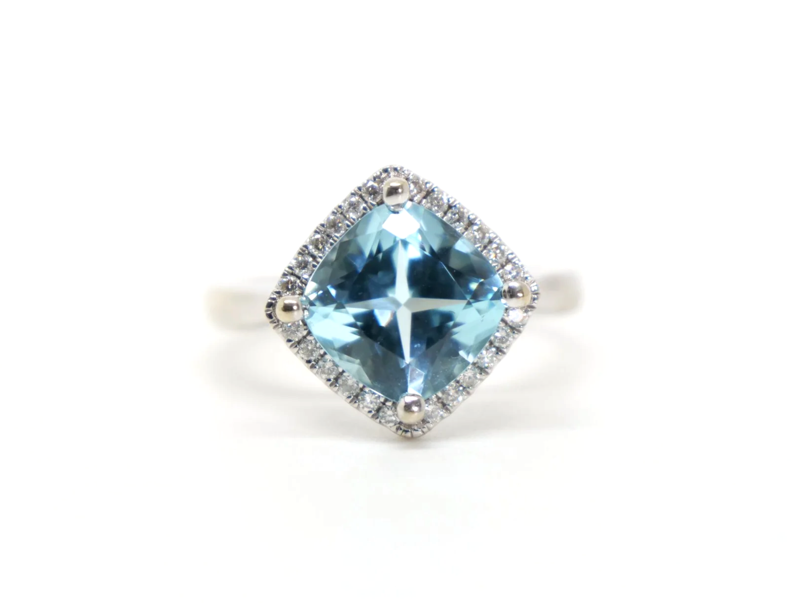 Beautiful contemporary 9ct gold blue topaz and diamond cocktail ring, set with a large cushion cut blue topaz of approximately 3.5ct with a brilliant cut diamond surround
