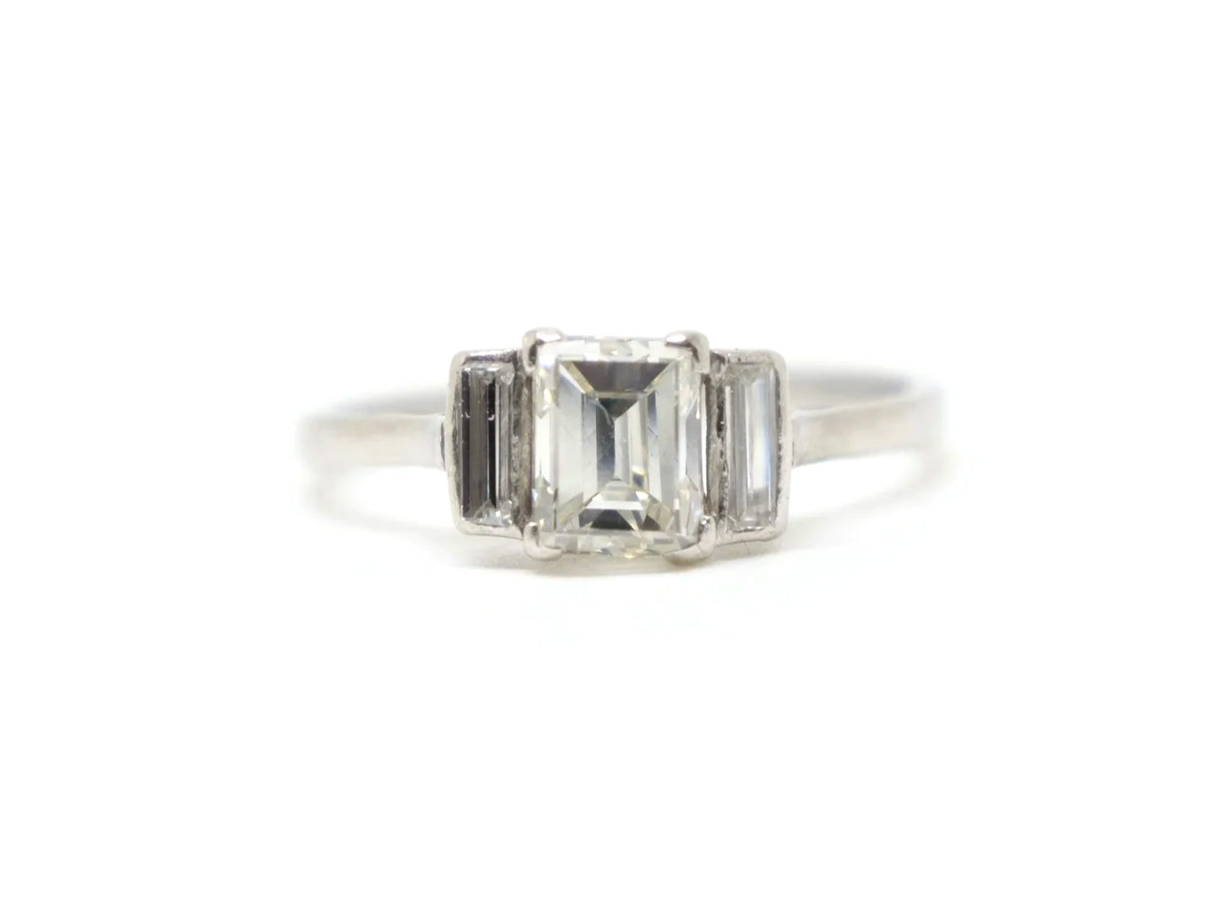 Very unusual vintage platinum diamond ring, set with a lovely baguette cut diamond of approximately 0.95ct. Two further baguette cut diamonds.