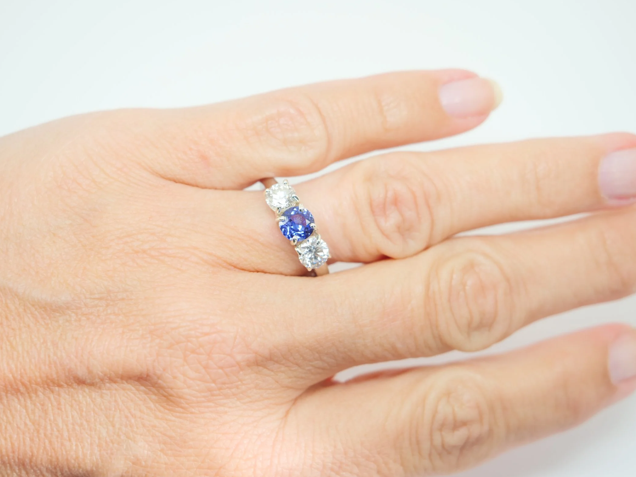 Platinum sapphire and diamond three stone ring, round cut sapphire centre 1.8ct