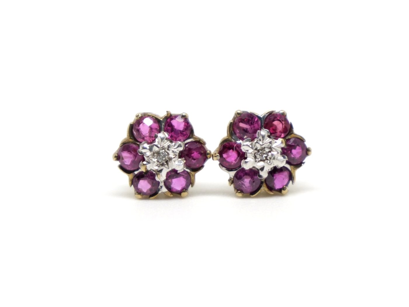 Beautiful ruby and diamond flower earrings in 9ct gold, each set with six round cut rubies and a single central diamond.