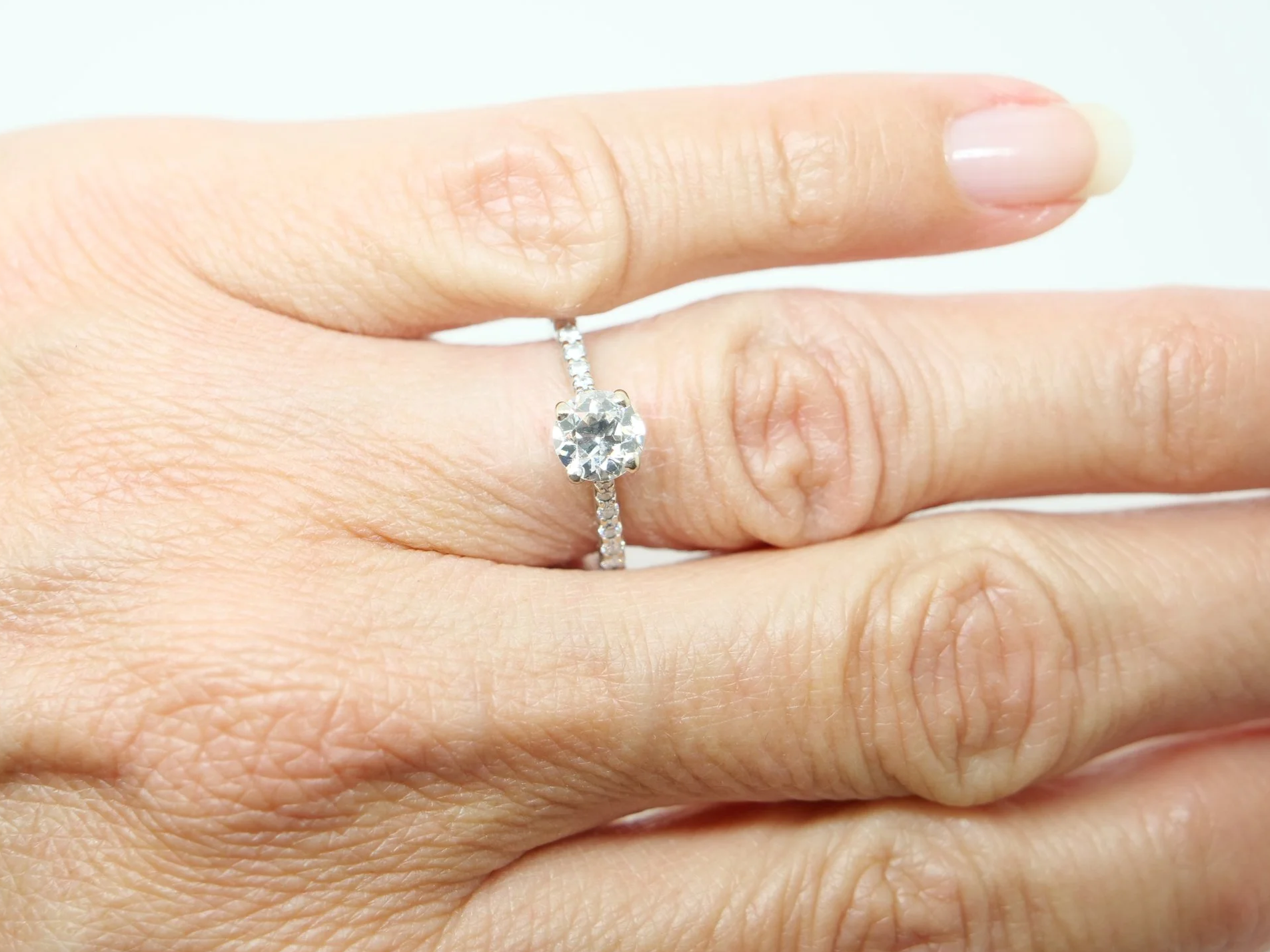 An 18ct gold old cut diamond solitaire with diamond-set shoulders