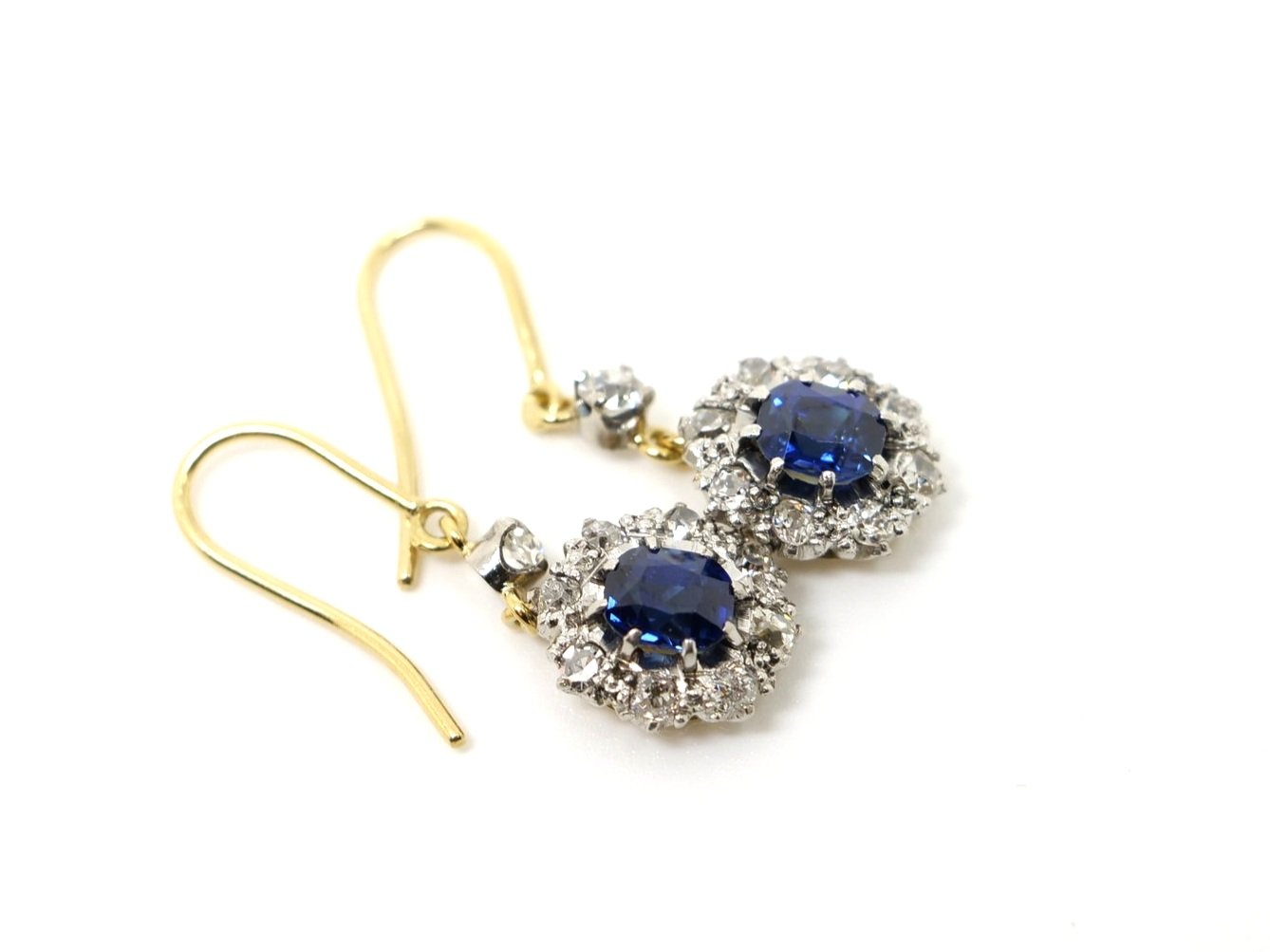 vintage drop earrings in 18ct gold, each set with a beautiful oval cut blue sapphire and surrounded by old cut diamonds.