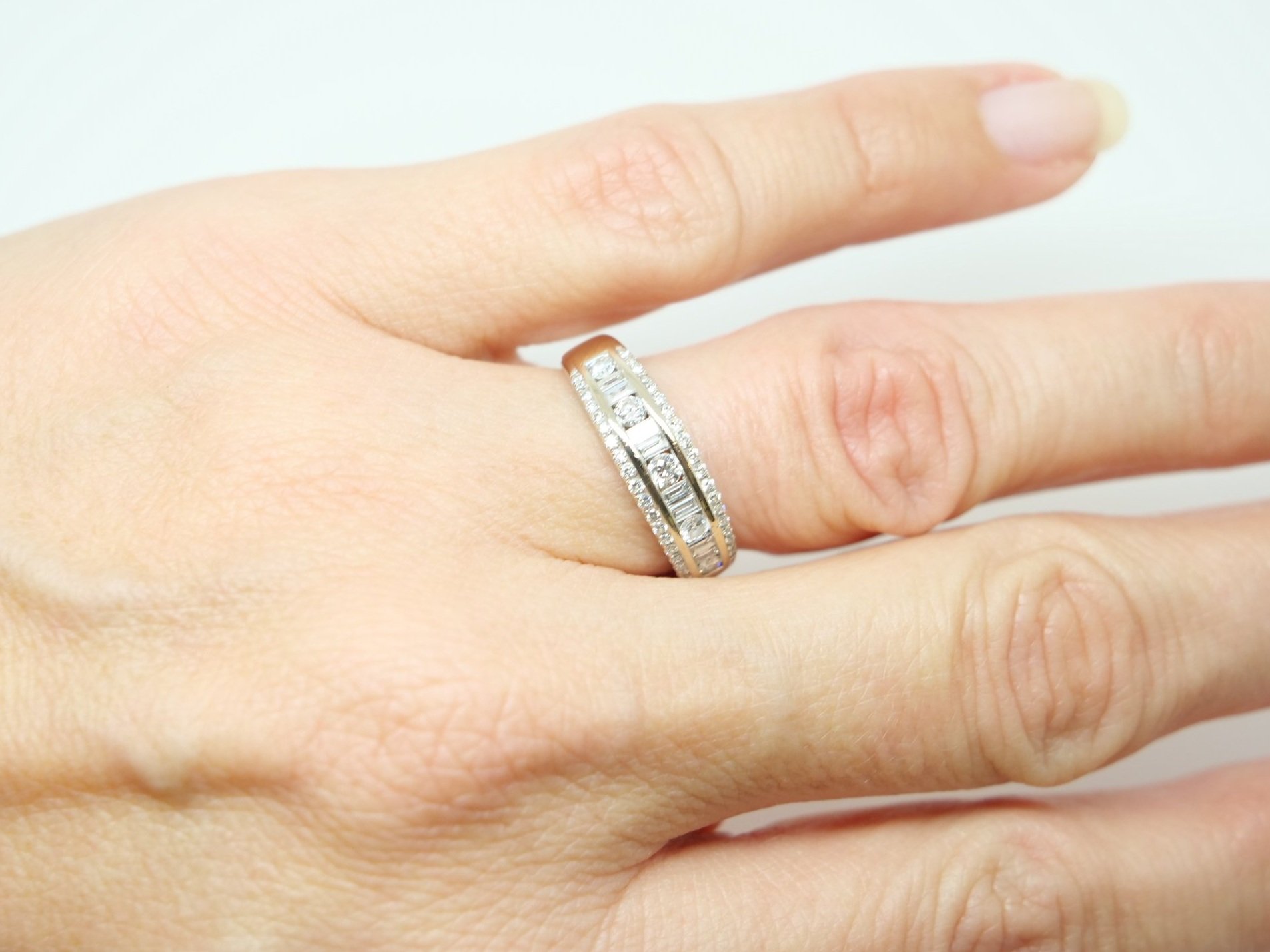 Unusual 18ct gold diamond half eternity ring, set with a mixture of brilliant and bagutte cut diamonds. Approximately 0.48ct diamonds overall.