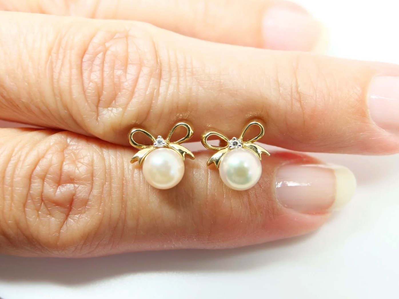 9ct yellow gold pearl and diamond bow stud earrings