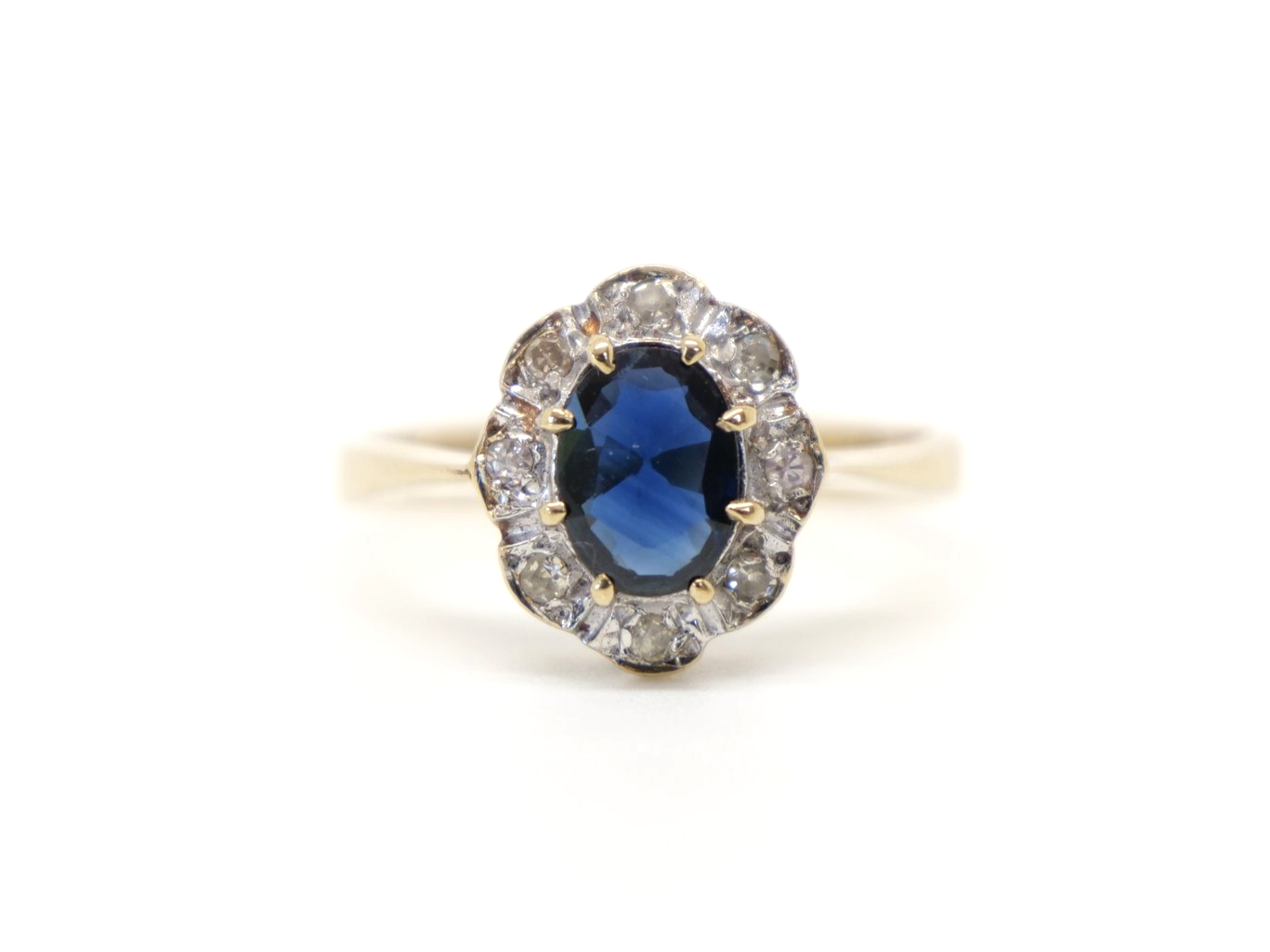 Very pretty vintage sapphire and diamond ring, set with a central oval cut sapphire of approximately 1ct and surrounded by small diamonds.
