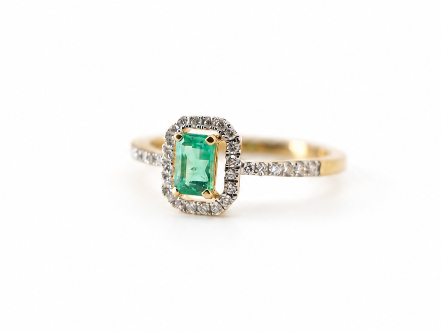 18ct gold emerald and diamond halo ring, emerald cut centre stone