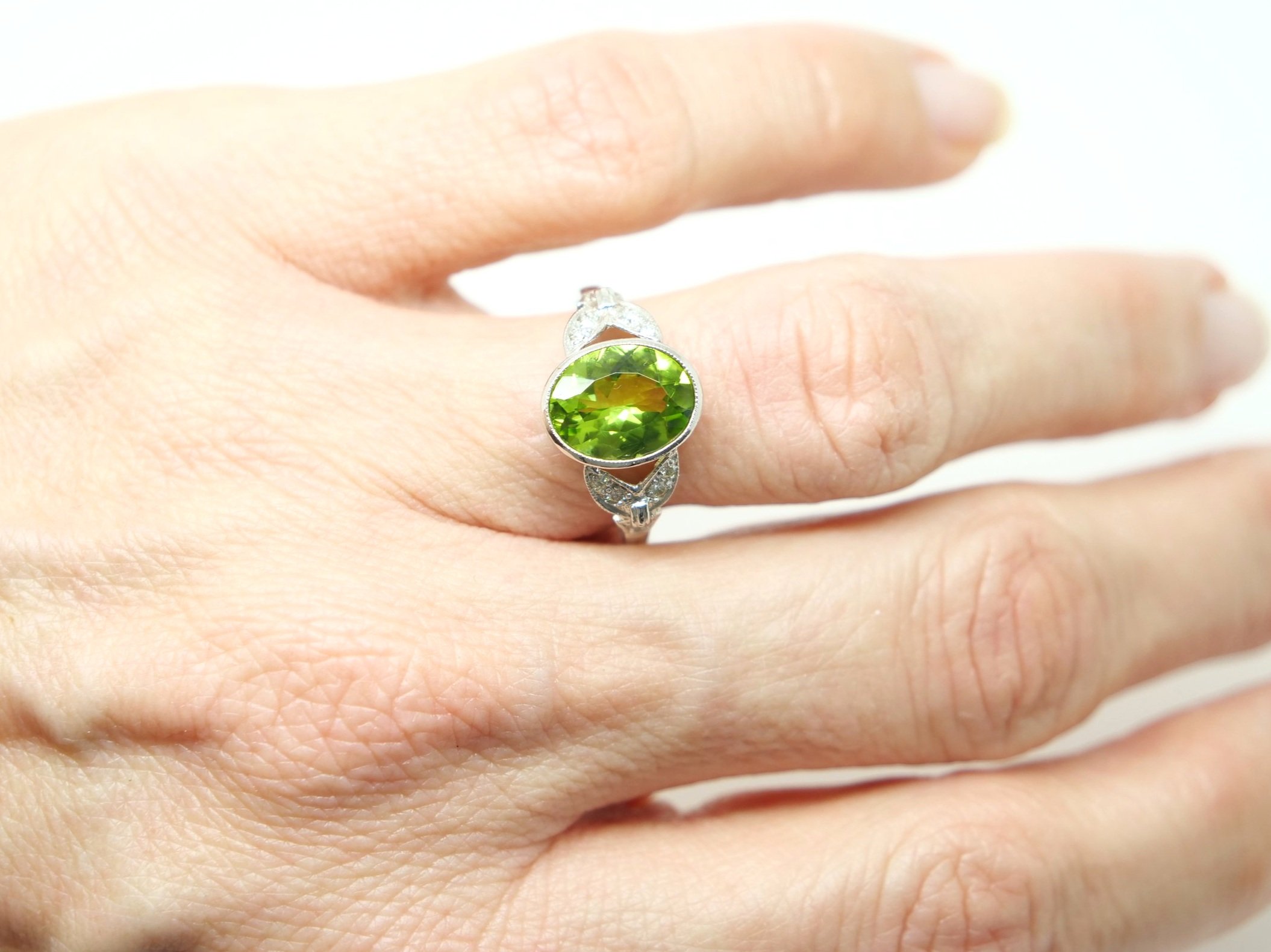 Lovely Art Deco style peridot and diamond ring, set with a centre oval cut peridot of approximately 2.5cts, with pretty diamond shoulders.