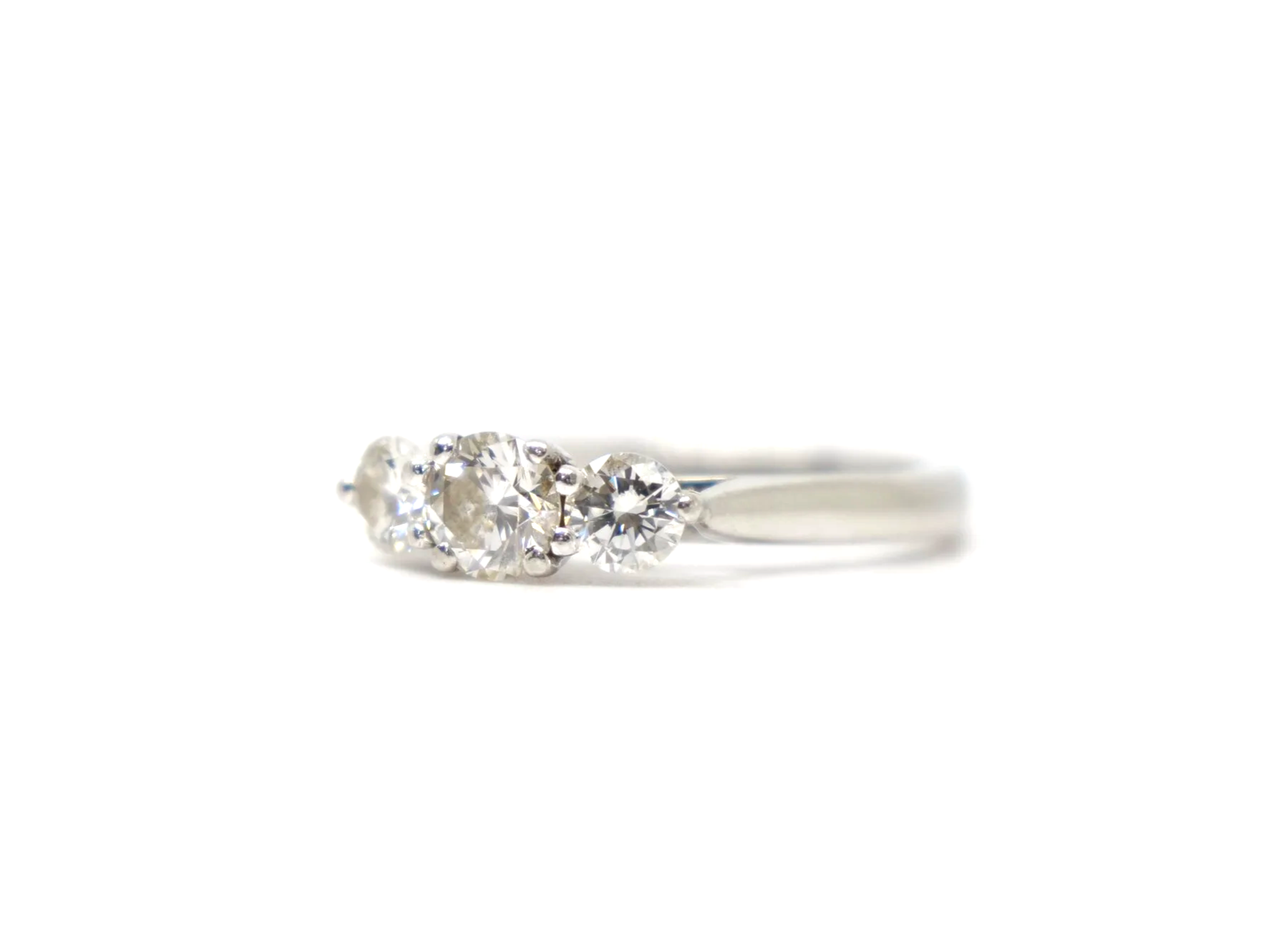 Platinum three stone diamond ring, three round brilliant cut diamonds in claw settings, hallmarked 2010, UK size L