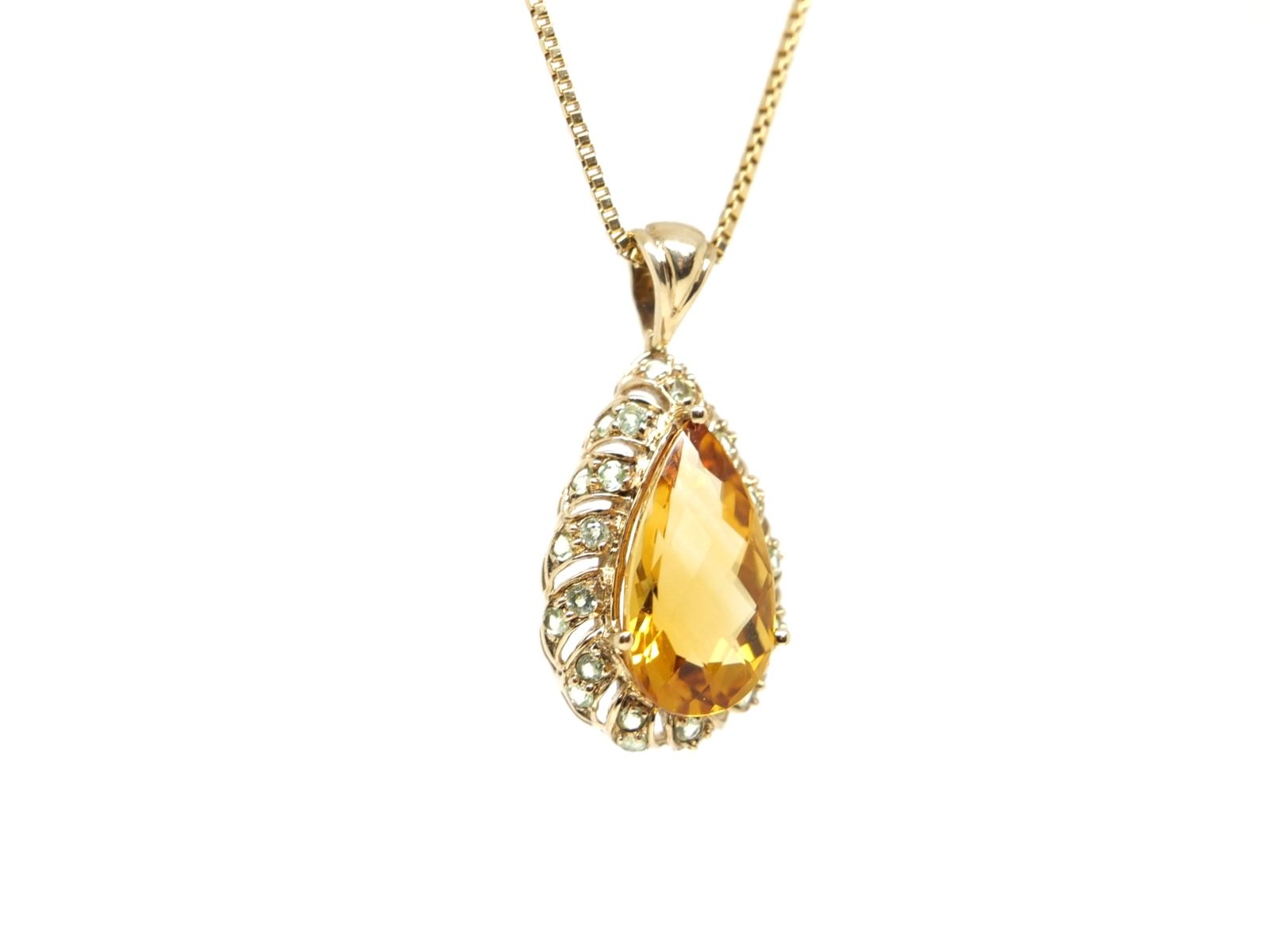 Beautiful 9ct gold citrine and aquamarine pendant, set with a cnetral pear cut citrine and surrounded by a double row of round cut aquamarines.