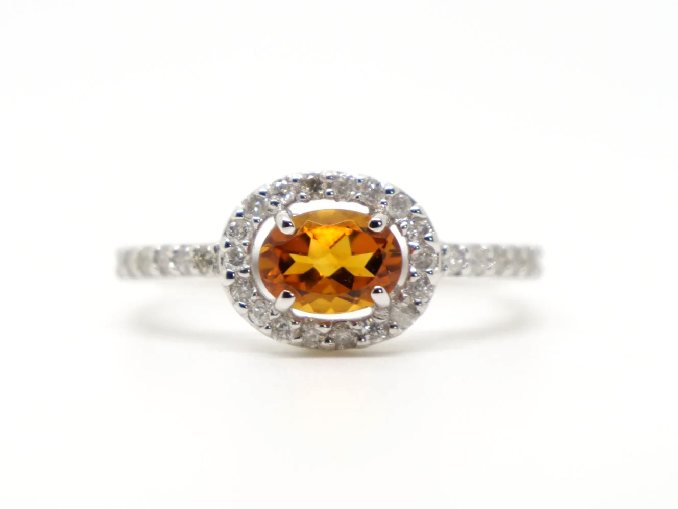 Very sparkly contemporary 18ct gold citrine and diamond ring, set with an oval cut east-west citrine, with a diamond halo.