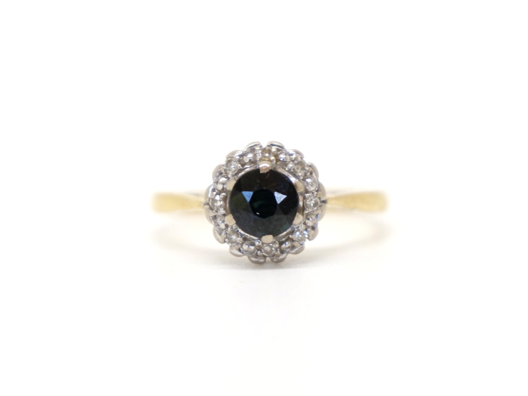 Classic vintage 18ct gold sapphire and diamond ring, set with a central, round cut sapphire of approximately 0.75ct and surrounded by diamonds.
