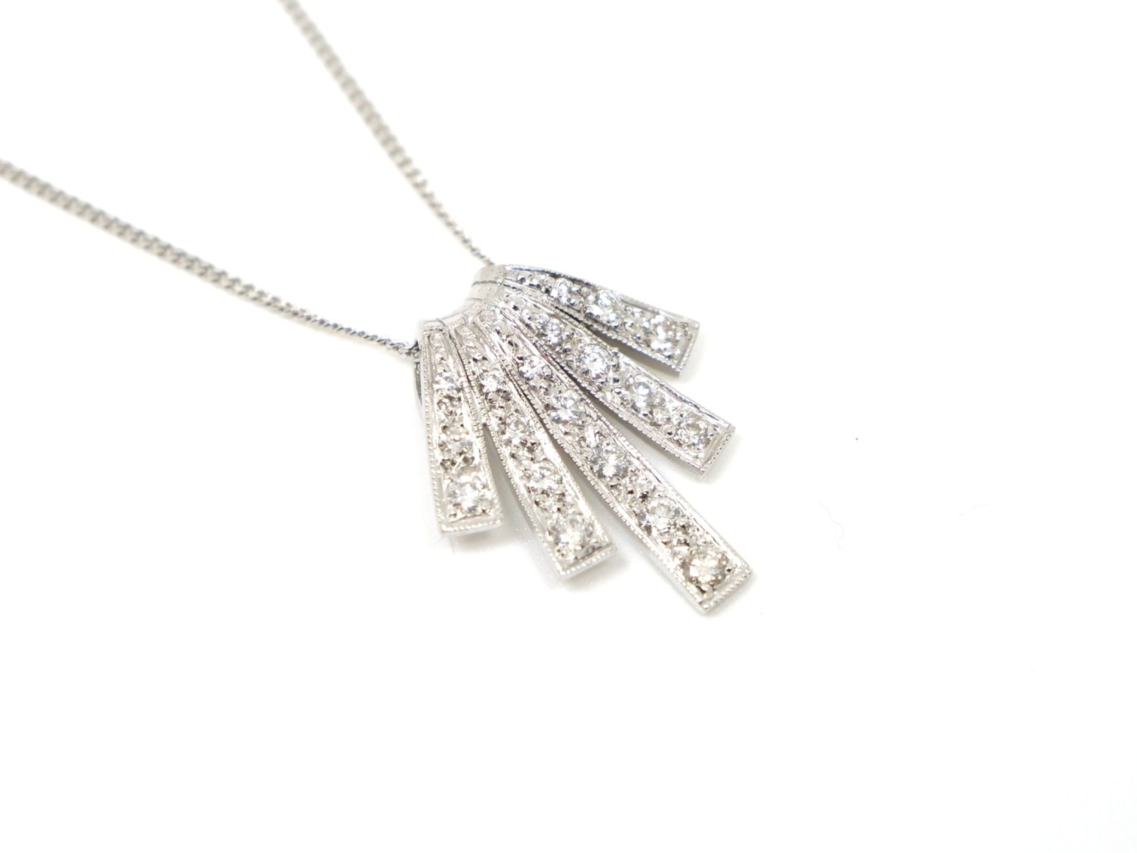 Stunning platinum diamond pendant in this wonderful Art Deco design. Approximately 0.7ct diamonds. With 18ct gold 18” chain.