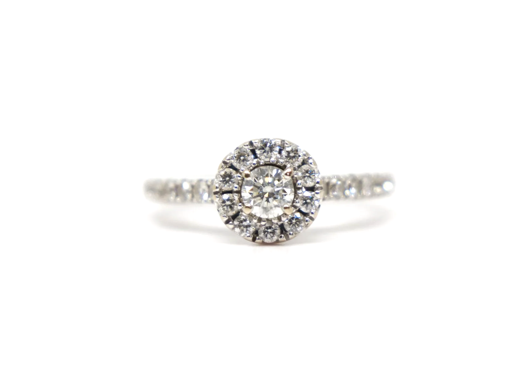 14ct white gold diamond halo ring set with a round brilliant cut diamond at the centre surrounded by a pavé-set halo of smaller diamonds