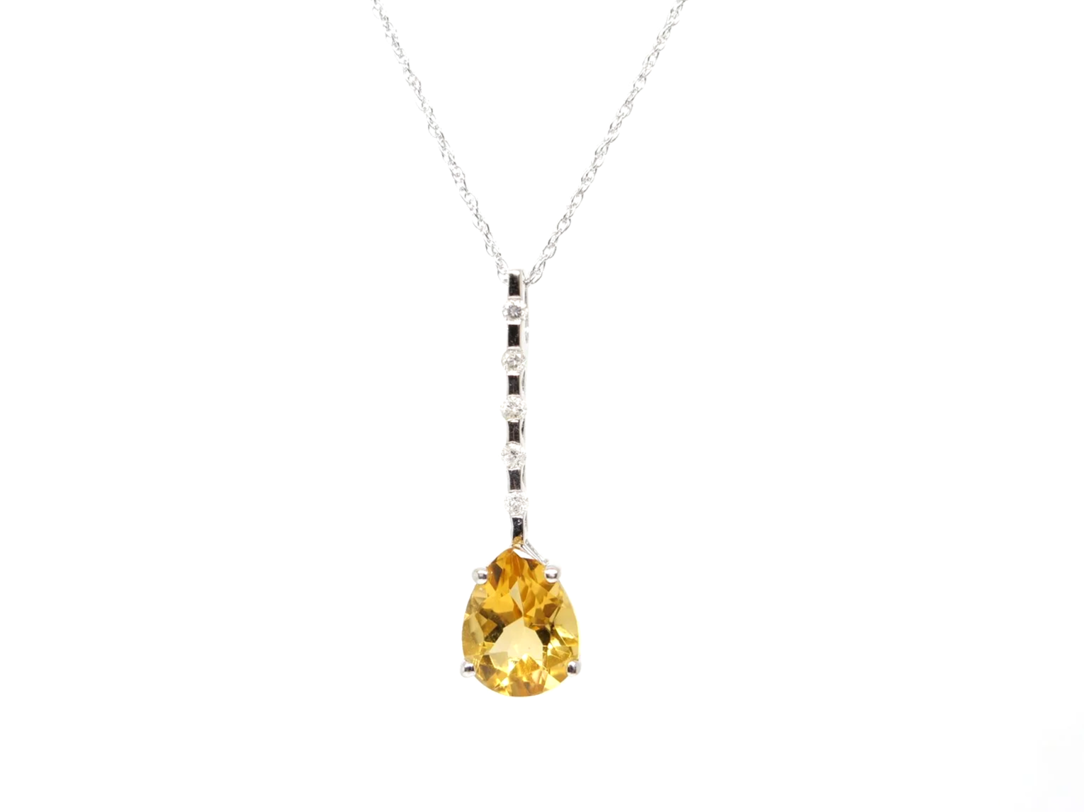A 9ct white gold citrine and diamond pendant