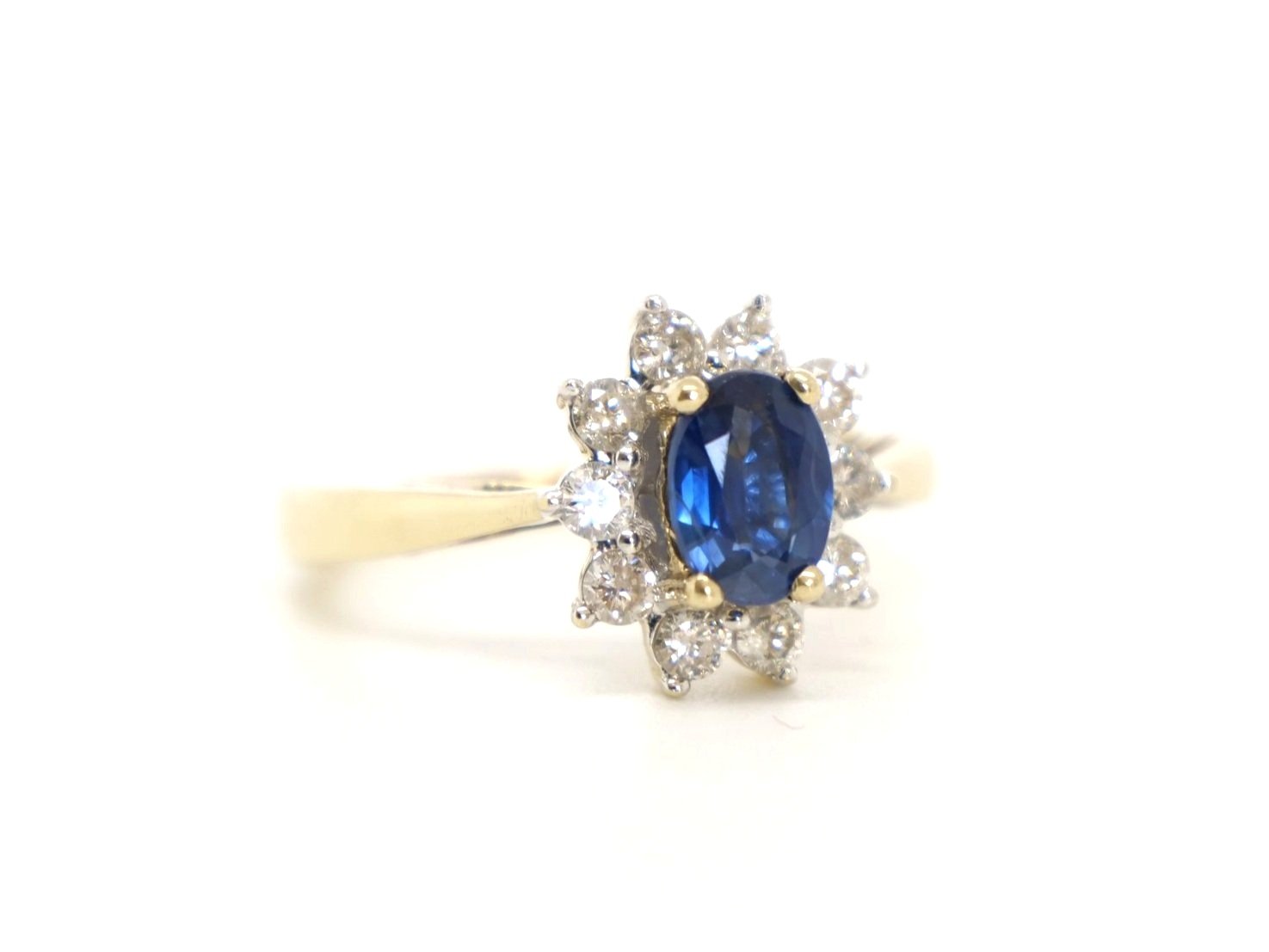 Lovely sapphire and diamond cluster ring, set with a 1ct oval cut mid blue sapphire and surrounded by 0.5ct brilliant cut diamonds.