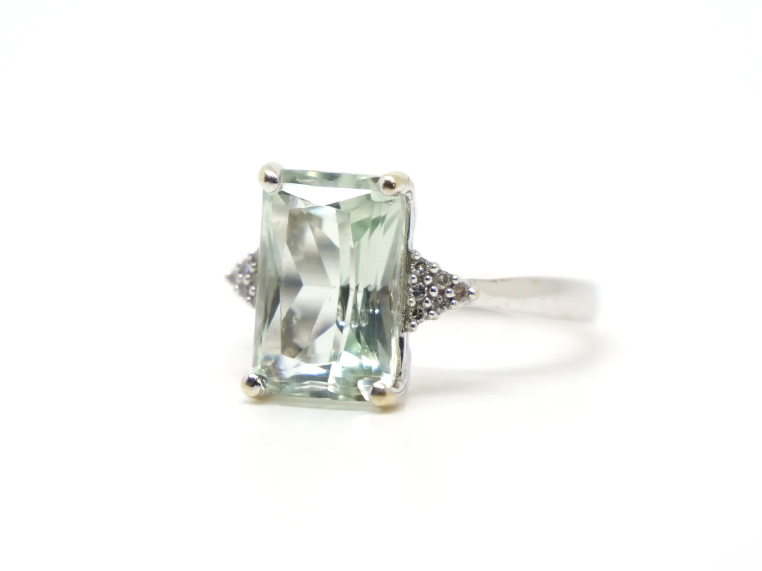 Lovely vintage 9ct gold cocktail ring set with a light green amethyst, with a cluster of small diamonds set to each shoulder..png
