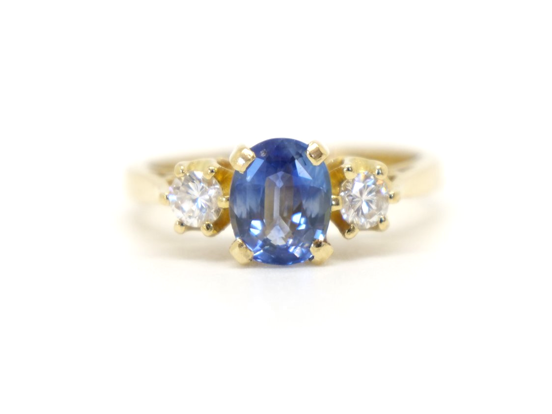 Lovely vintage 18ct gold sapphire and diamond trilogy ring, set with a 1ct oval cut emerald and with a brilliant cut diamond to each side.