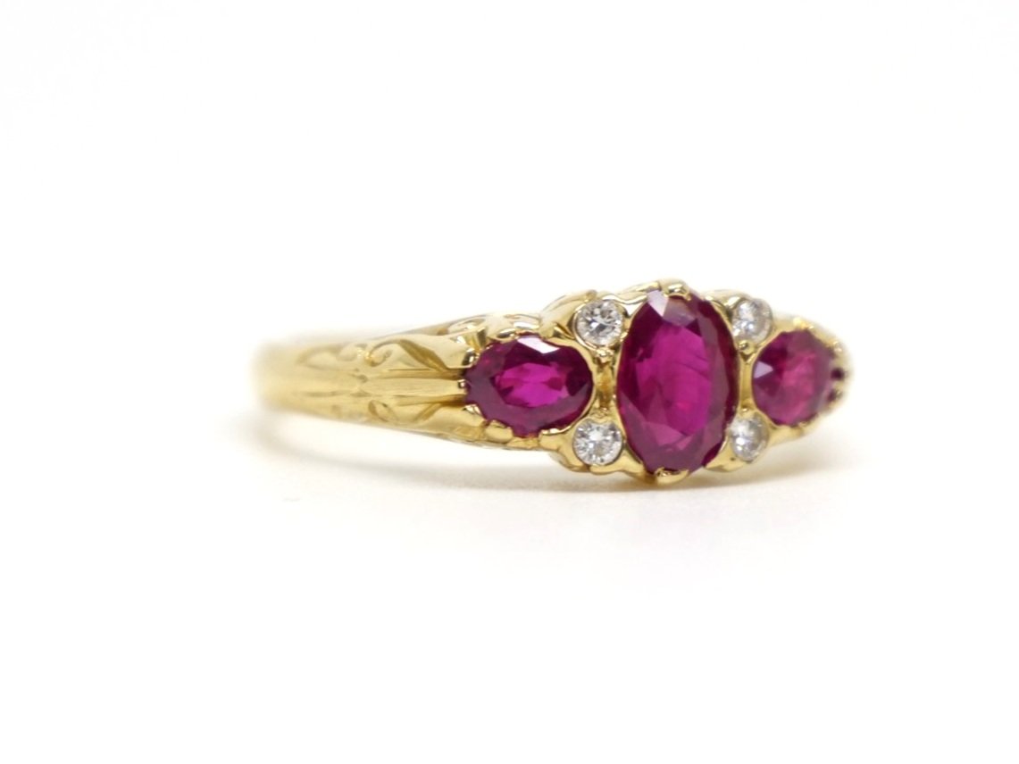 Lovely vintage 18ct gold ruby and diamond ring in this lovely traditional Victorian style. Set with three oval cut rubies with small accent diamonds.