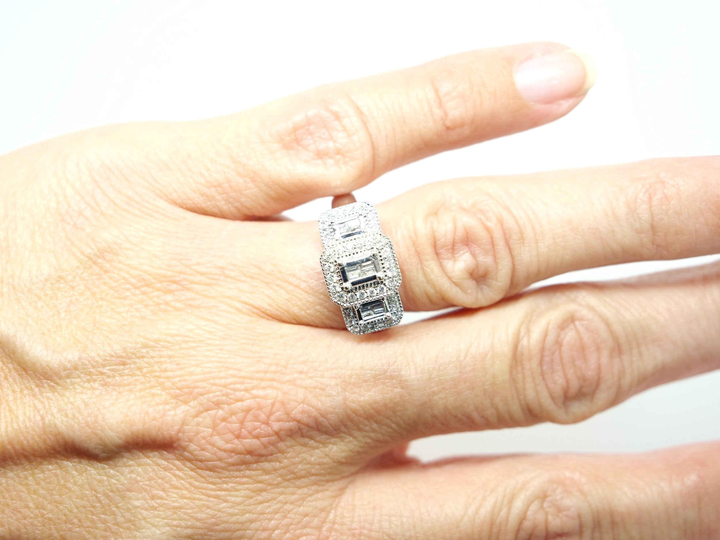 Lovely 18ct gold vintage style diamond cluster ring in a three stone design, set with a mixture of baguette cut and brilliant cut diamonds. Wonderful statement piece.