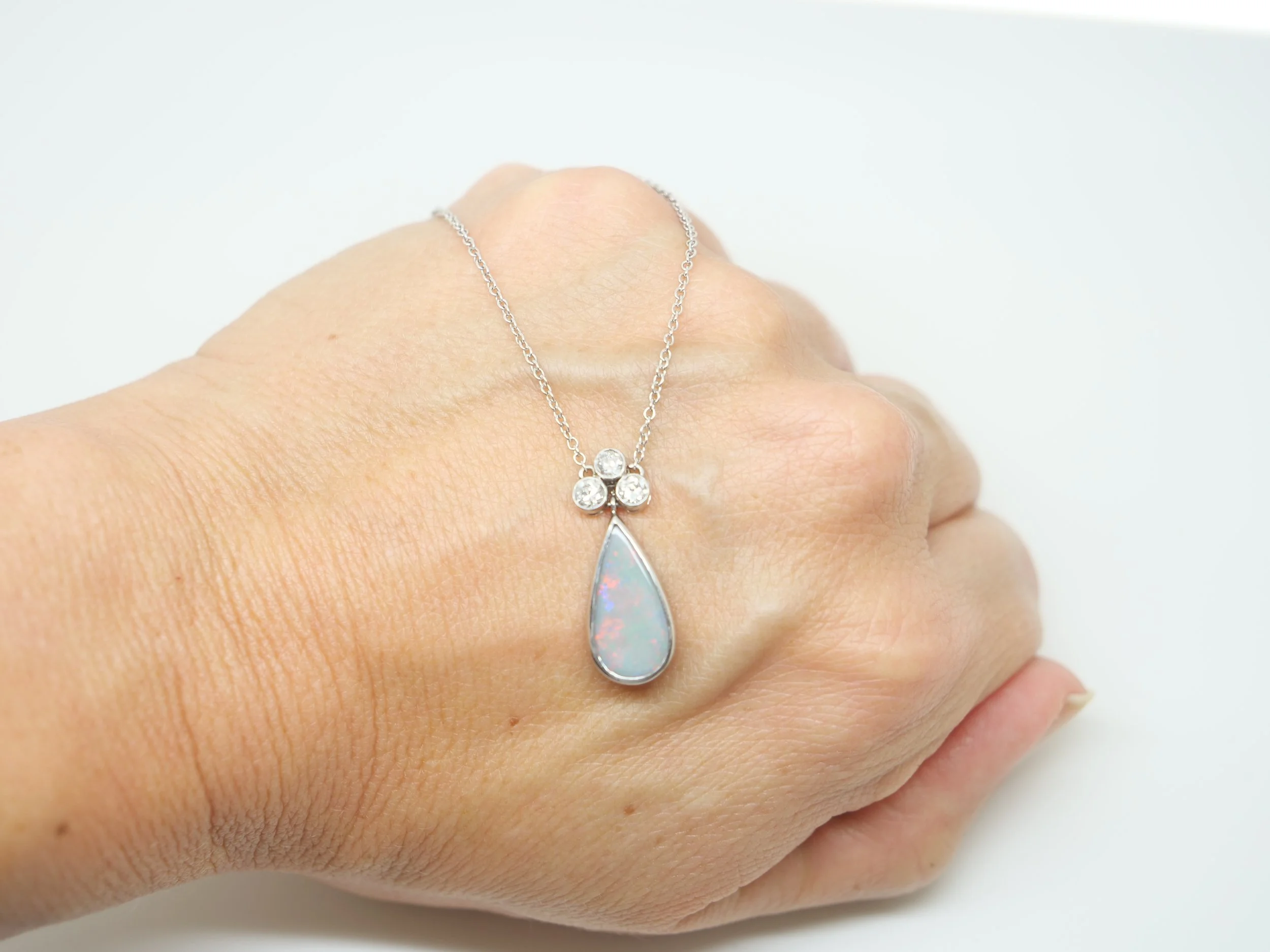 Stunning vintage 18ct gold black opal and old cut diamond pendant necklace, with a pear cut black opal and three old cut diamonds, with a 9ct gold chain.