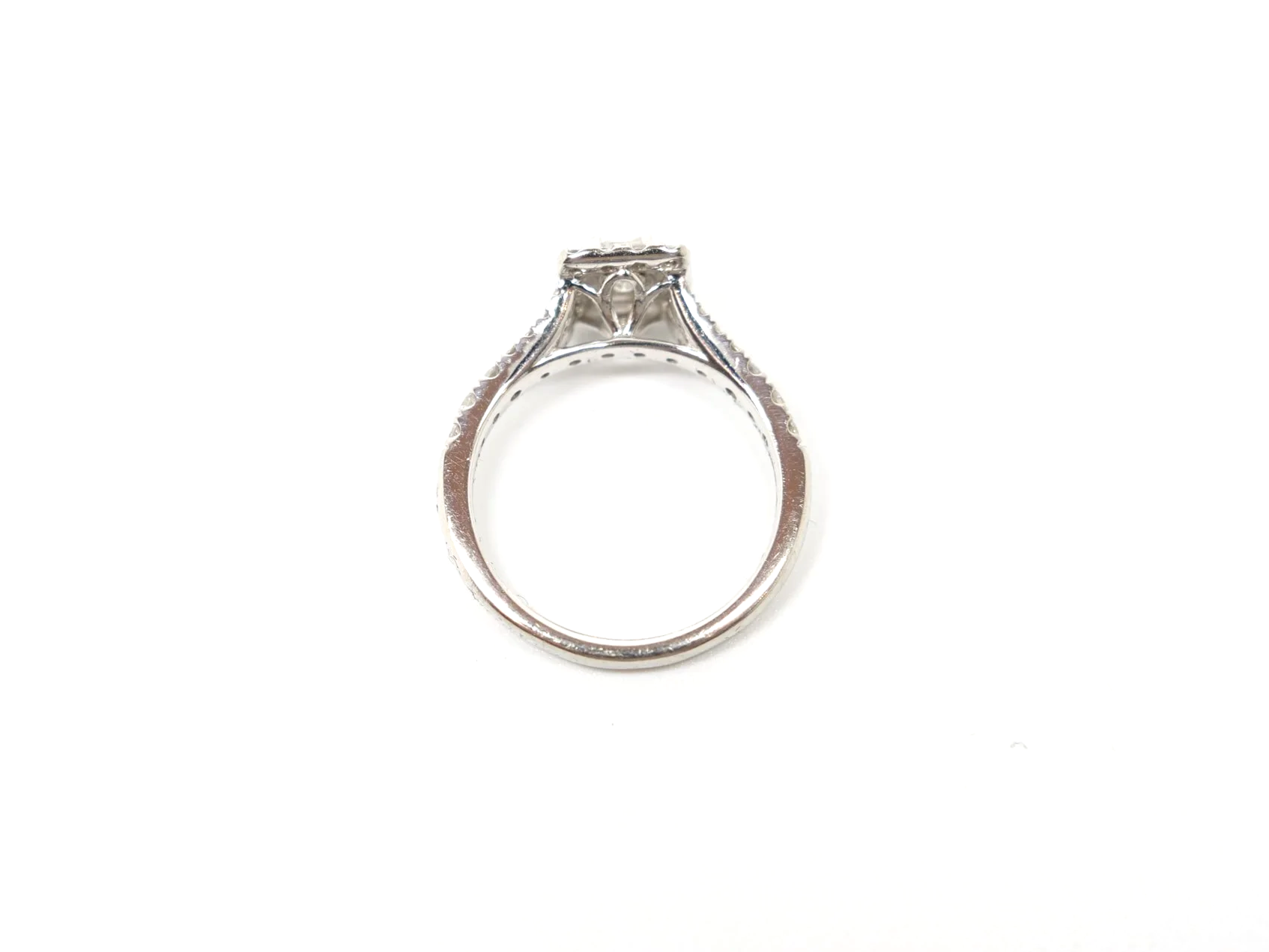 platinum diamond cluster ring set with an emerald-cut diamond at the centre, surrounded by a rectangular pavé-set halo of round brilliant-cut diamonds