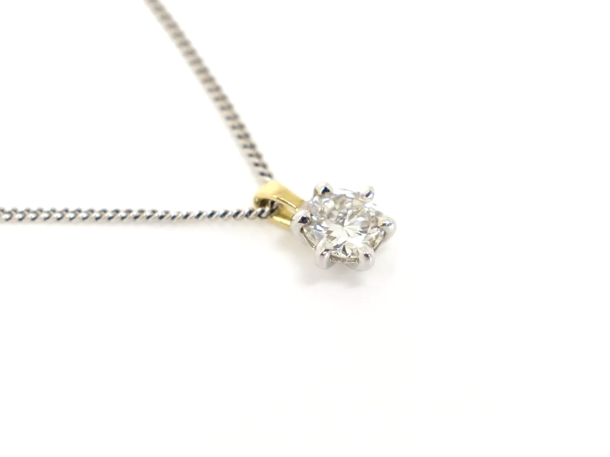 Classic 18ct gold diamond solitaire pendant, set with a very sparkly brilliant cut diamond. Diamond set in white gold with yellow gold bale.