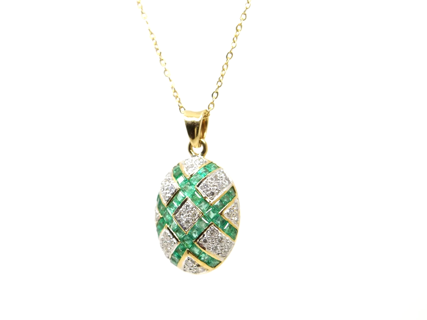 Unusual 18ct gold emerald and diamond pendant in this lovely lattice style design. Set with brilliant cut diamonds and step cut emeralds. With 16” 18ct gold chain.