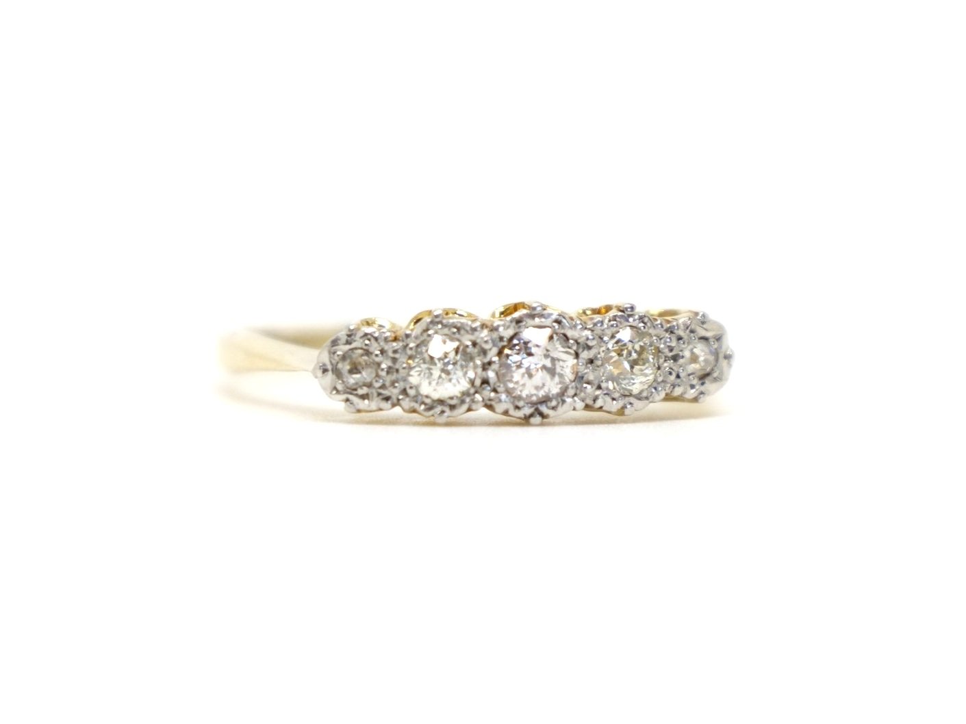 Pretty vintage 18ct gold ring, set with five old cut diamonds. Diamonds have a pretty platinum setting that enhances the appearance and size of the diamonds.