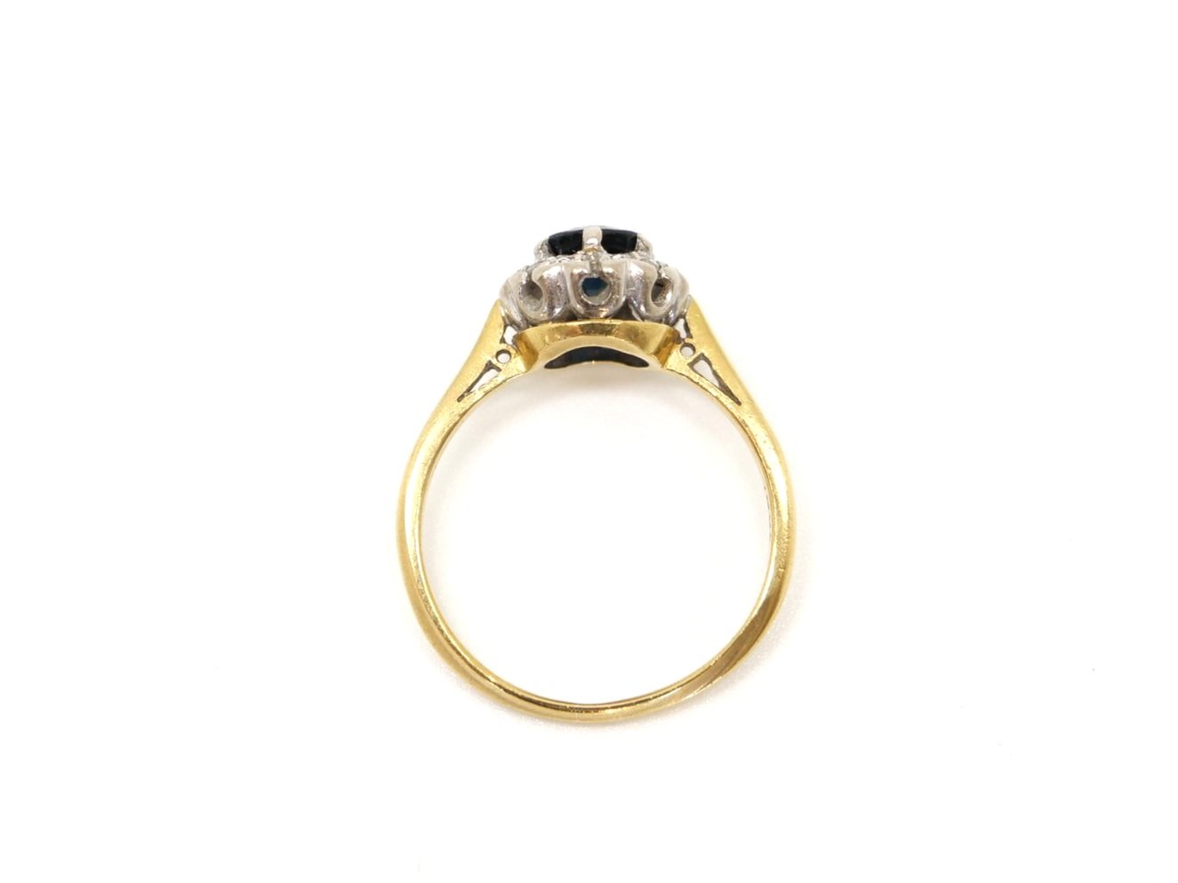 Classic vintage 18ct gold sapphire and diamond ring, set with a central, round cut sapphire of approximately 0.75ct and surrounded by diamonds.