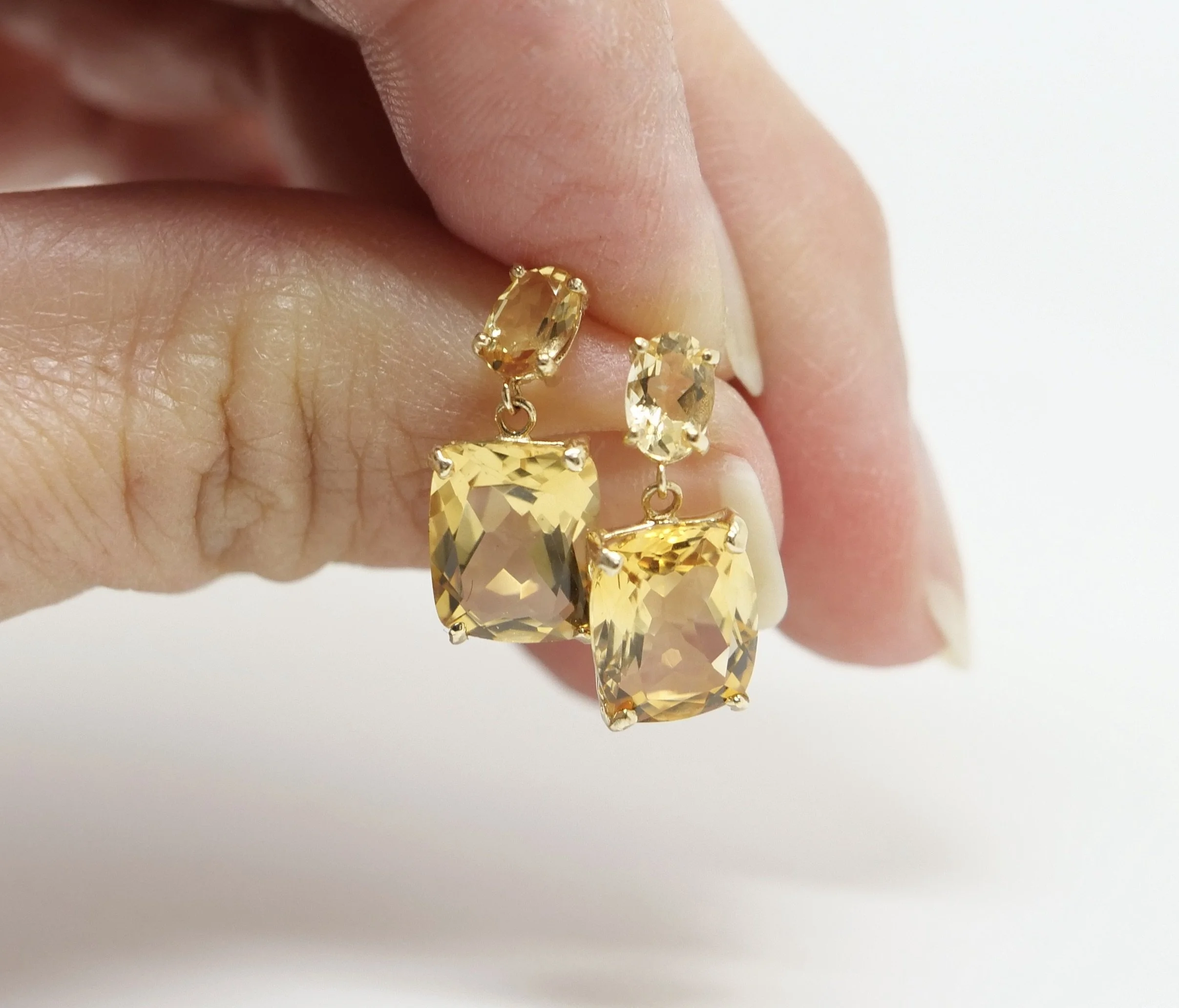 Lovely statement drop earrings in 14ct gold, each set with a smaller oval citrine and a larger cushion cut citrine. With 14ct gold butterfly backs.