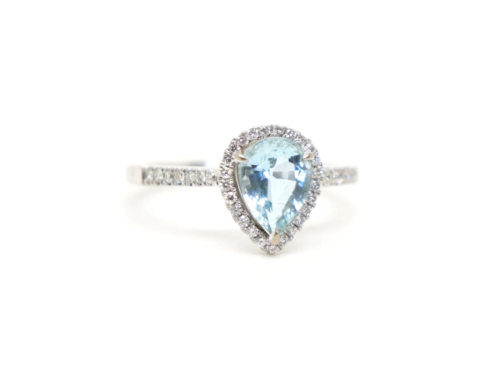 18ct white gold aquamarine and diamond halo ring, set with a pear cut aquamarine at the centre