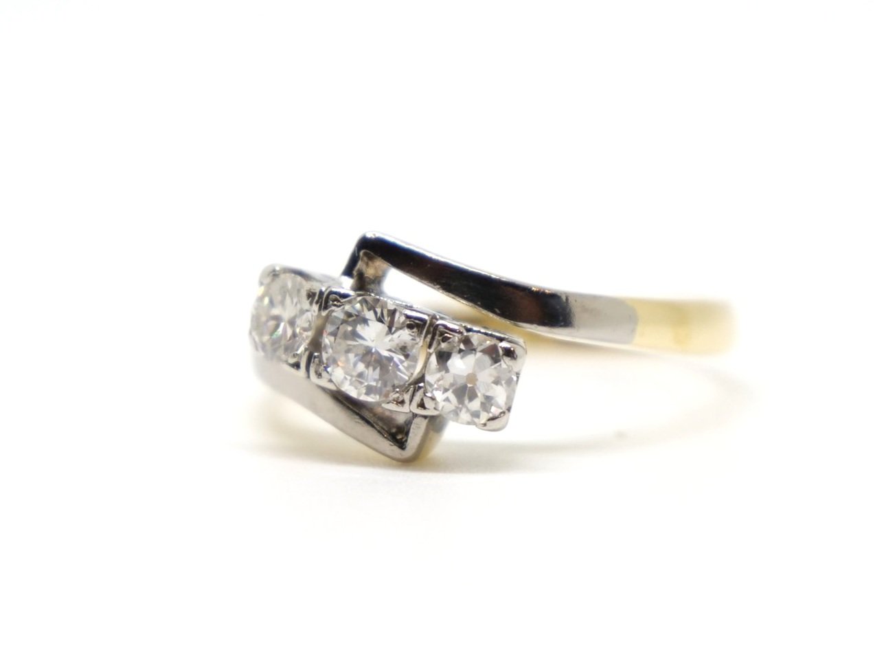 Very pretty Art Deco 18ct and Platinum diamond ring, set with three diamonds in this twist design so typical of the period.