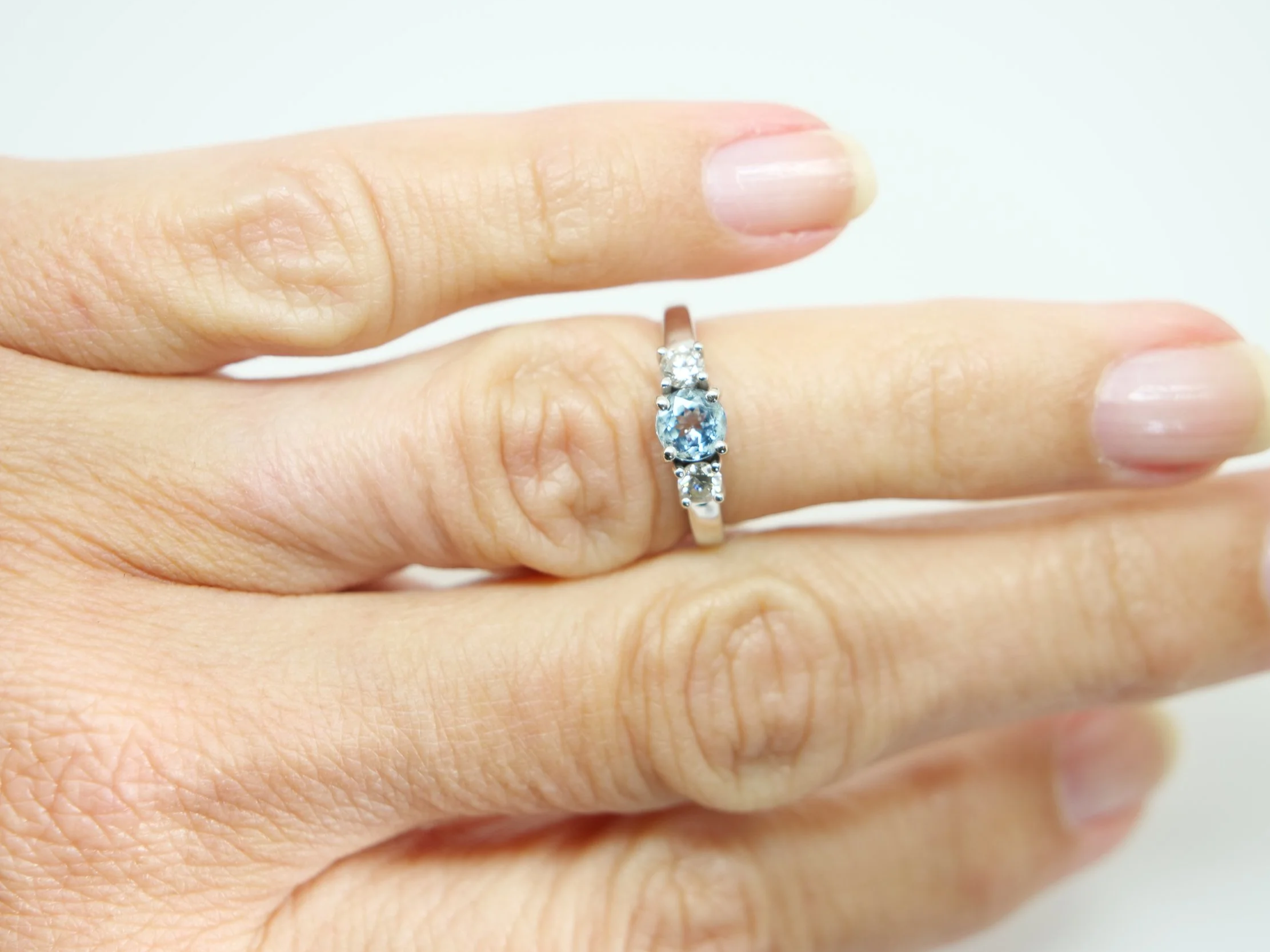 14ct gold aquamarine and diamond three stone ring, round cut aquamarine centre