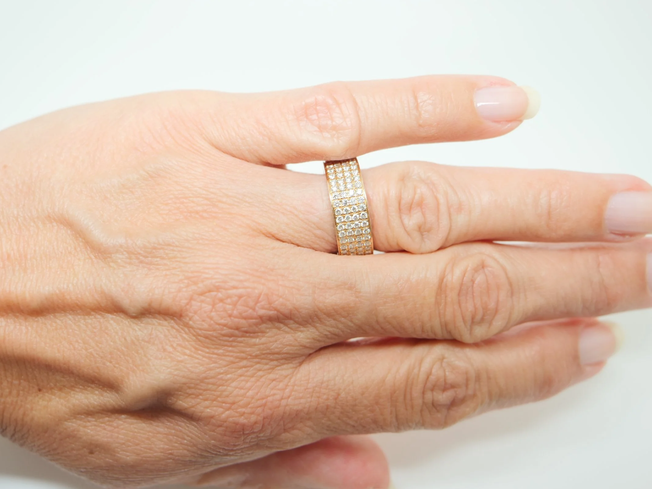 18ct yellow gold full eternity ring set with four continuous rows of round brilliant cut diamonds