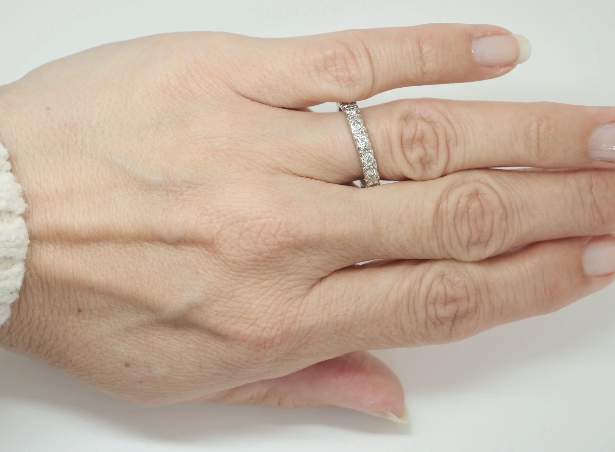 A platinum full eternity ring set with round brilliant cut diamonds all the way around the band — 1.5 carats
