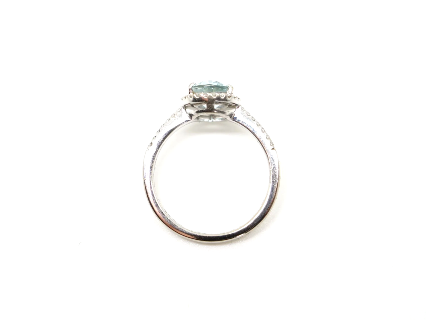 18ct white gold aquamarine and diamond halo ring, set with a pear cut aquamarine at the centre
