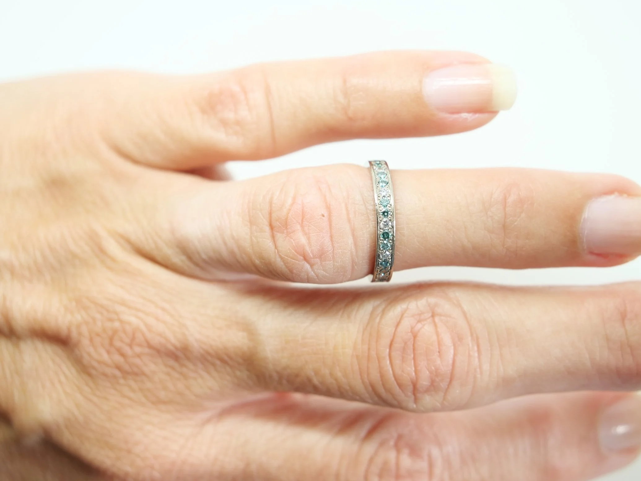 An 18ct white gold eternity ring alternating brilliant-cut white and blue diamonds, 0.59ct total. UK size I½. A rare vintage find, ready to ship.