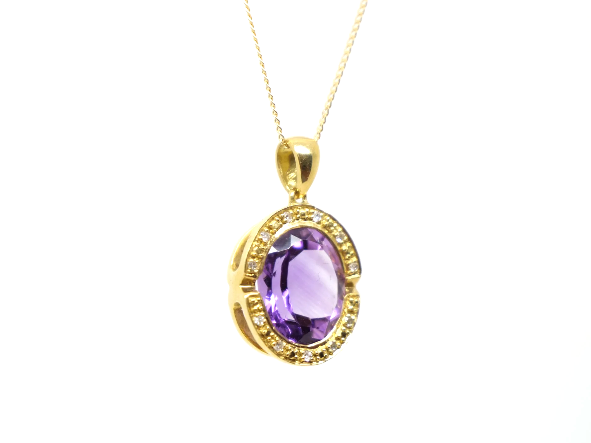 An 18ct gold pendant necklace with a large oval amethyst of approximately 4.5ct in a diamond-set halo.