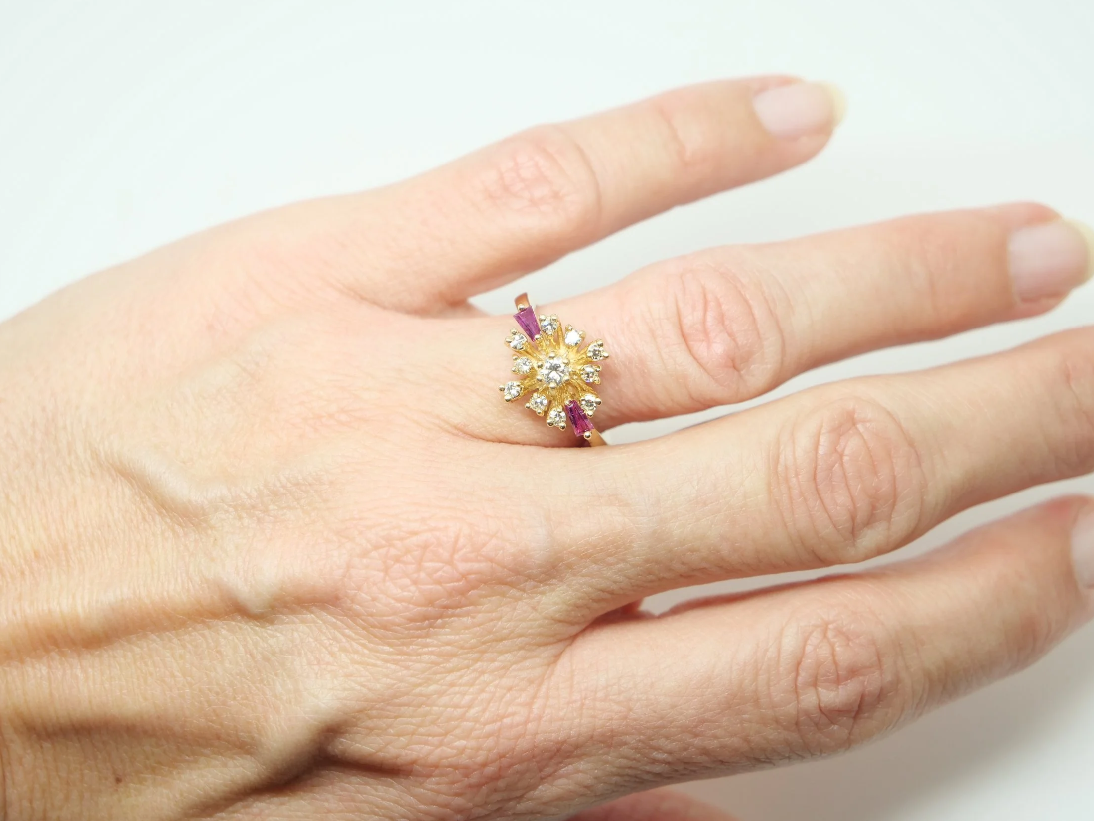 Unusual vintage 14ct gold ruby and diamond spray design ring, with a diamond centre and further diamonds in this east west marquise design. Highlighted with two tapered baguette cut rubies.