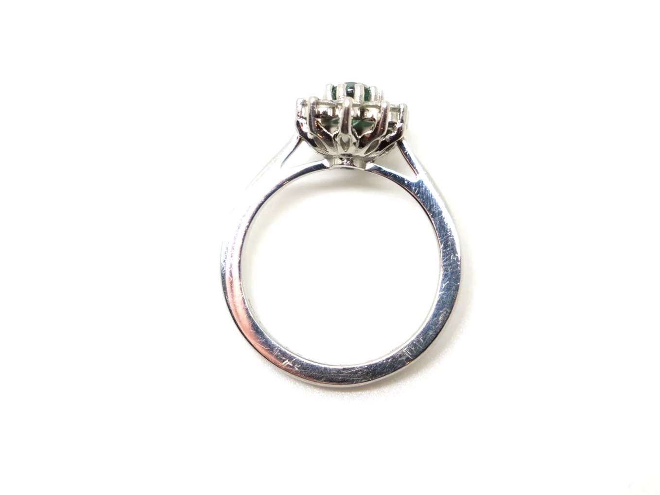 Unusual platinum green tourmaline and diamond cluster ring, set with an oval cut green tourmaline and surrounded by lovely sparkly diamonds.