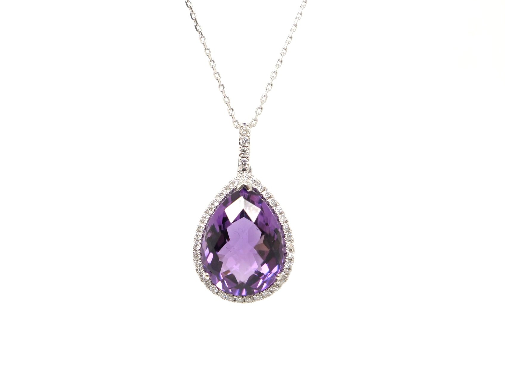 Very pretty 14ct gold amethyst and diamond pendant, set with a large pear cut amethyst and surrounded by diamonds. Further diamonds to bale. With 9ct white gold chain.